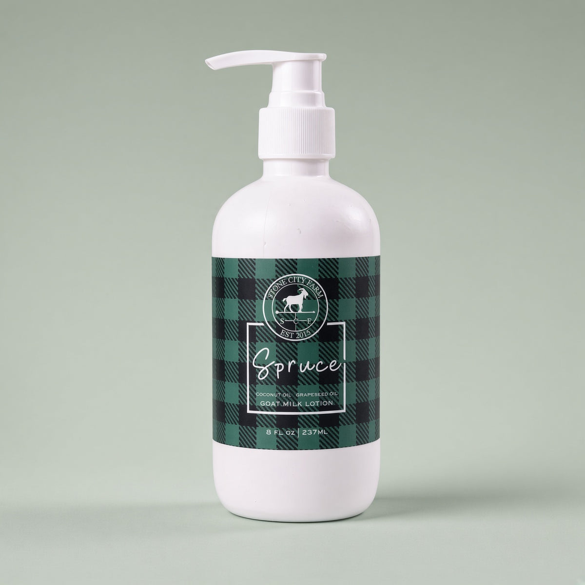 Spruce goat milk lotion on a sage green backdrop